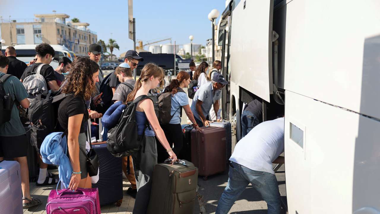 Passengers from the Crown Iris a cruise ship board buses, at the port of Larnaca