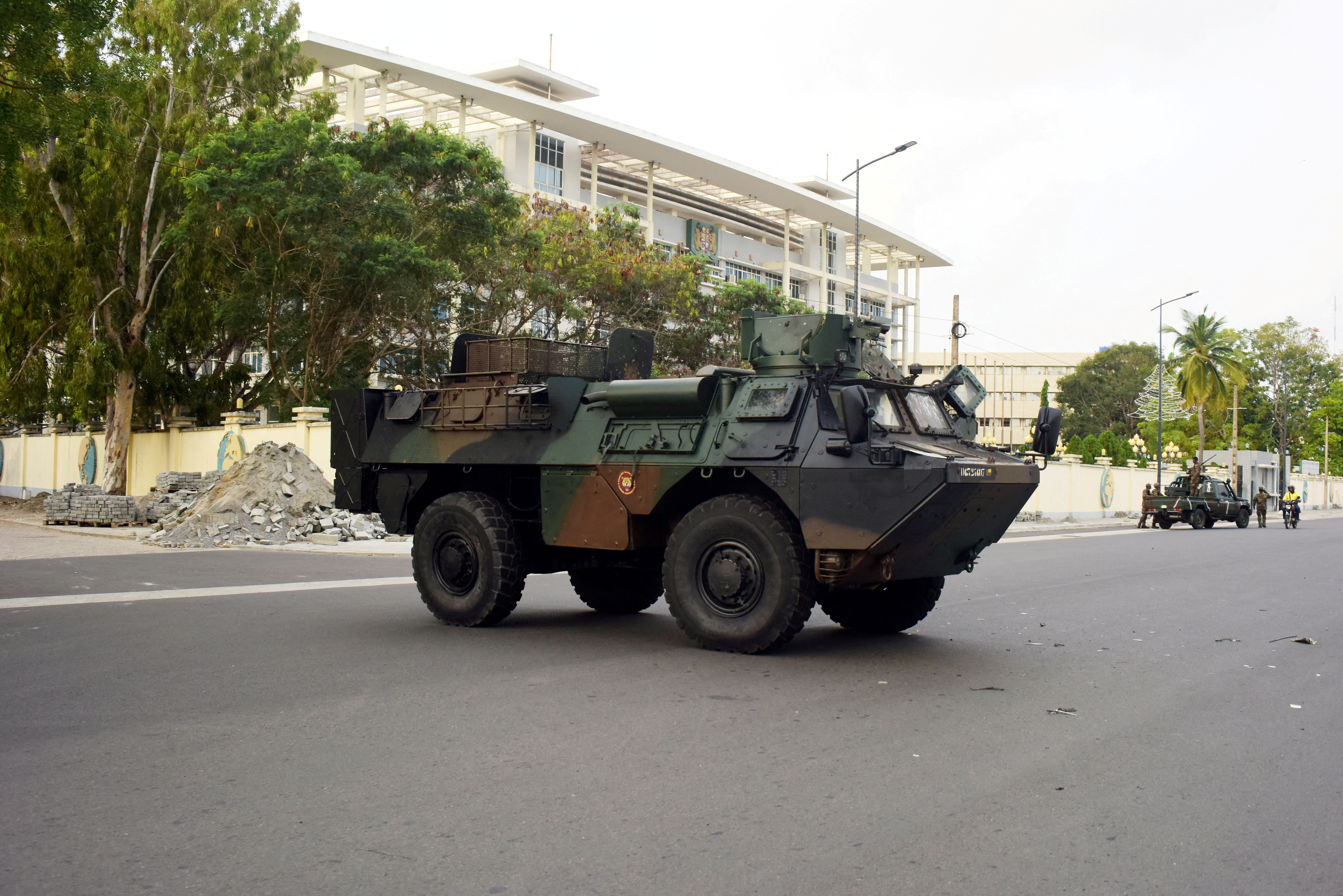 FILE PHOTO: Military armoured vehicles take position, in front of the headquarters of Benin's radio and television station in Cotonou