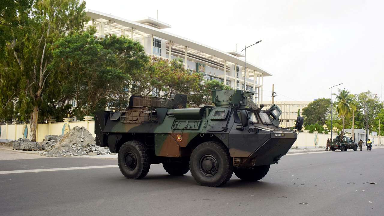 FILE PHOTO: Military armoured vehicles take position, in front of the headquarters of Benin's radio and television station in Cotonou