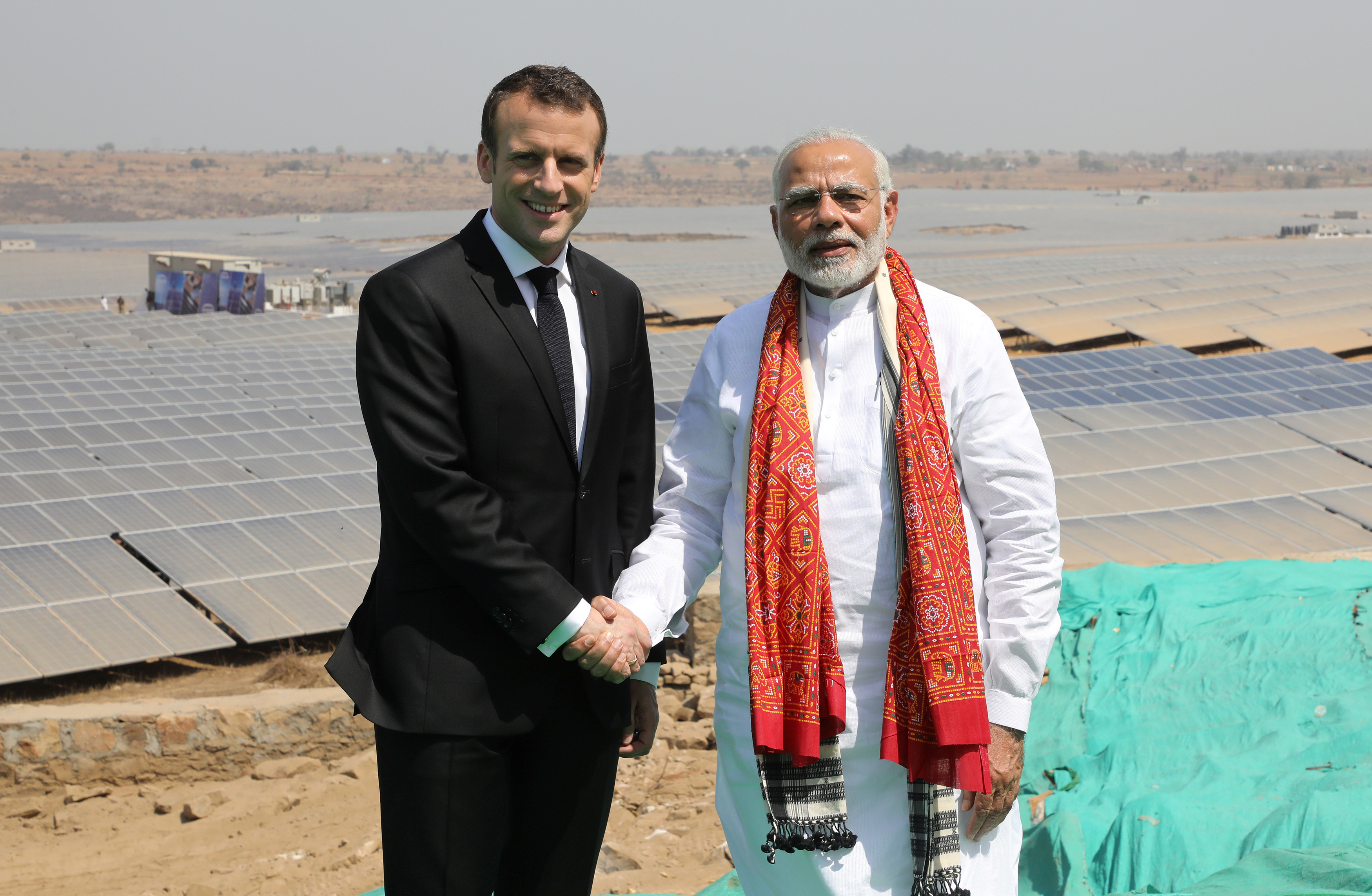 Indian Prime Minister Narendra Modi and French President Emmanuel Macron pose during the inauguration of a solar power plant in Mirzapur