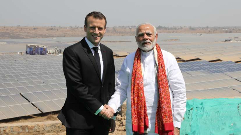 Indian Prime Minister Narendra Modi and French President Emmanuel Macron pose during the inauguration of a solar power plant in Mirzapur