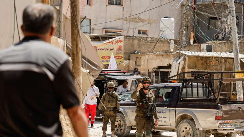 Palestinians carry their belongings after Israel's decision to demolish their homes in Nur Shams camp