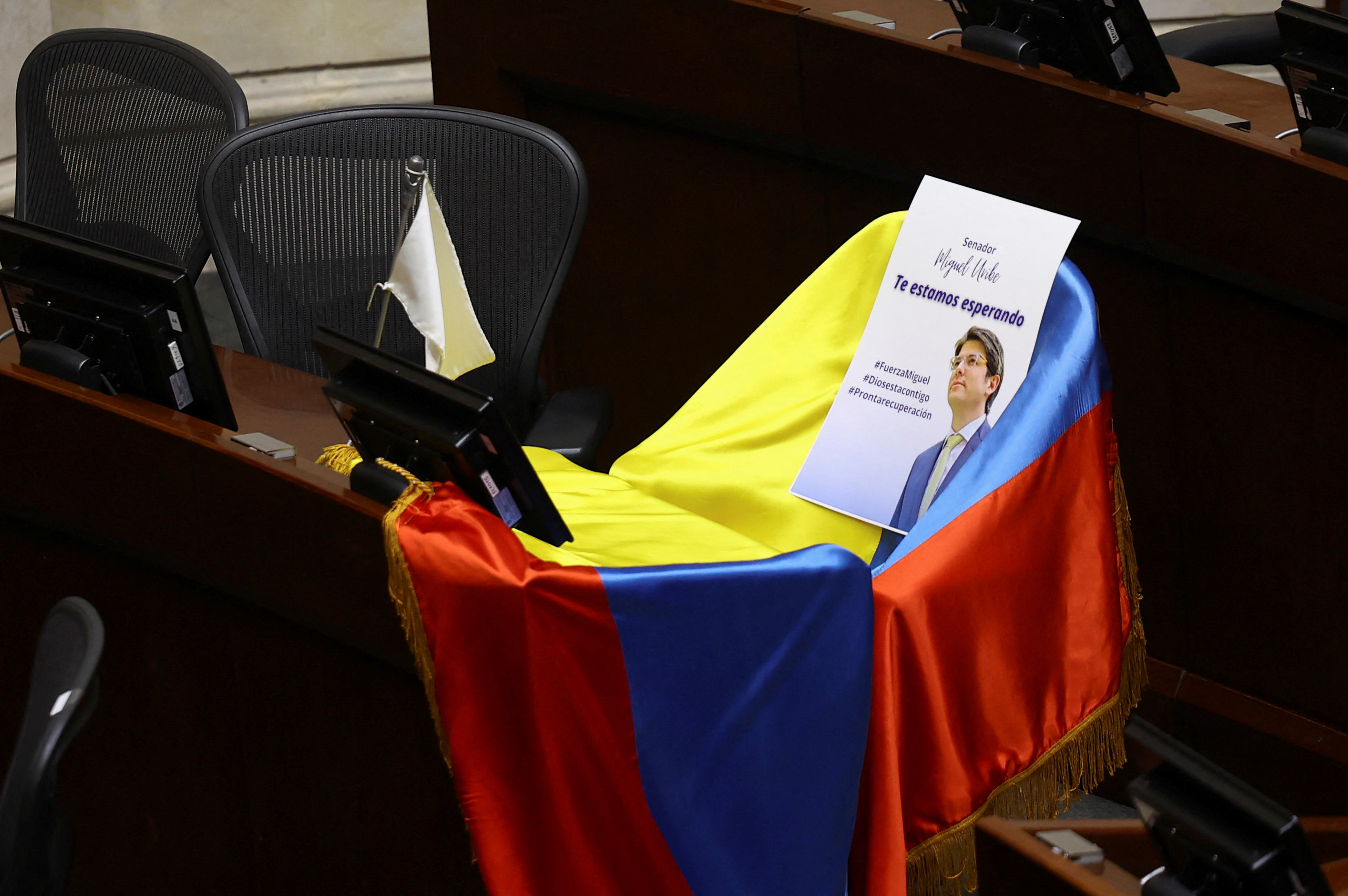 A flag and a card lie on the seat of Senator Miguel Uribe Turbay after he was shot, in Bogota
