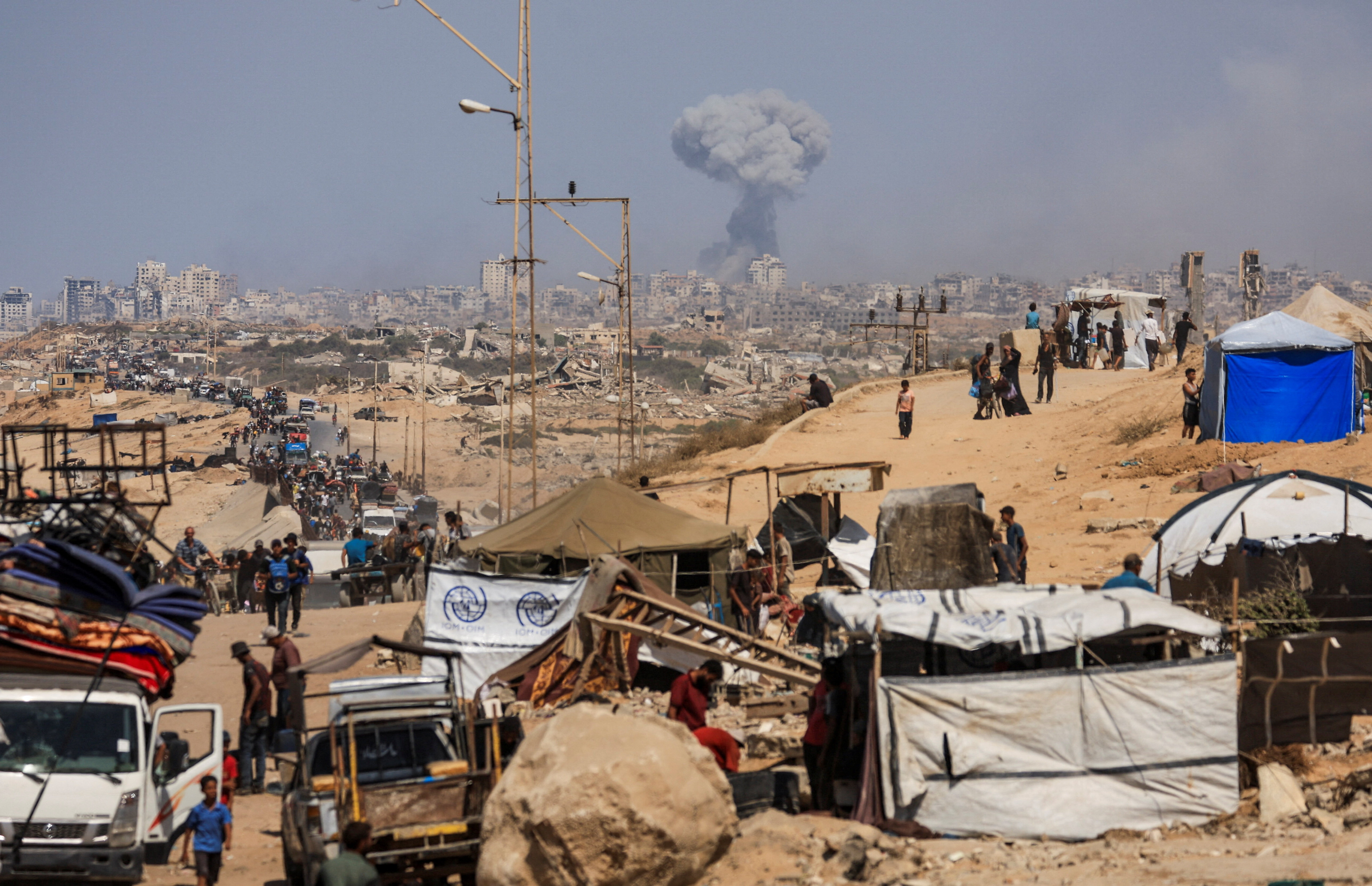Displaced Palestinians flee southward in the central Gaza Strip after Israeli forces ordered residents of Gaza City to evacuate