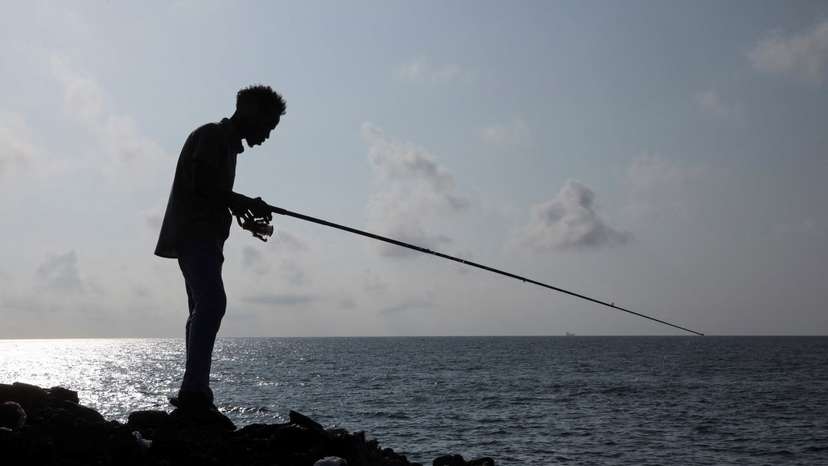 A man fishes in the Indian Ocean waters in Hamarweyne district of Mogadishu