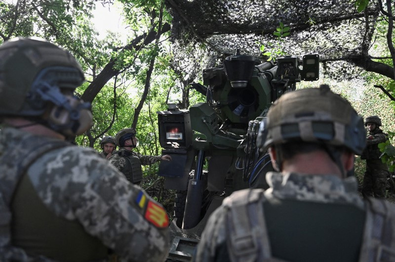 Ukraine servicemen prepare a Caesar self-propelled howitzer to fire towards Russian troops, outside the town of Pokrovsk
