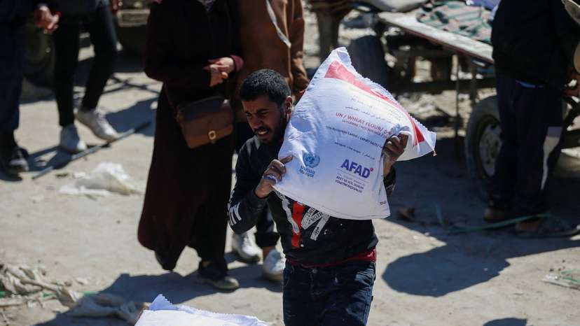 Palestinians gather to receive aid, at Jabalia refugee camp in northern Gaza Strip