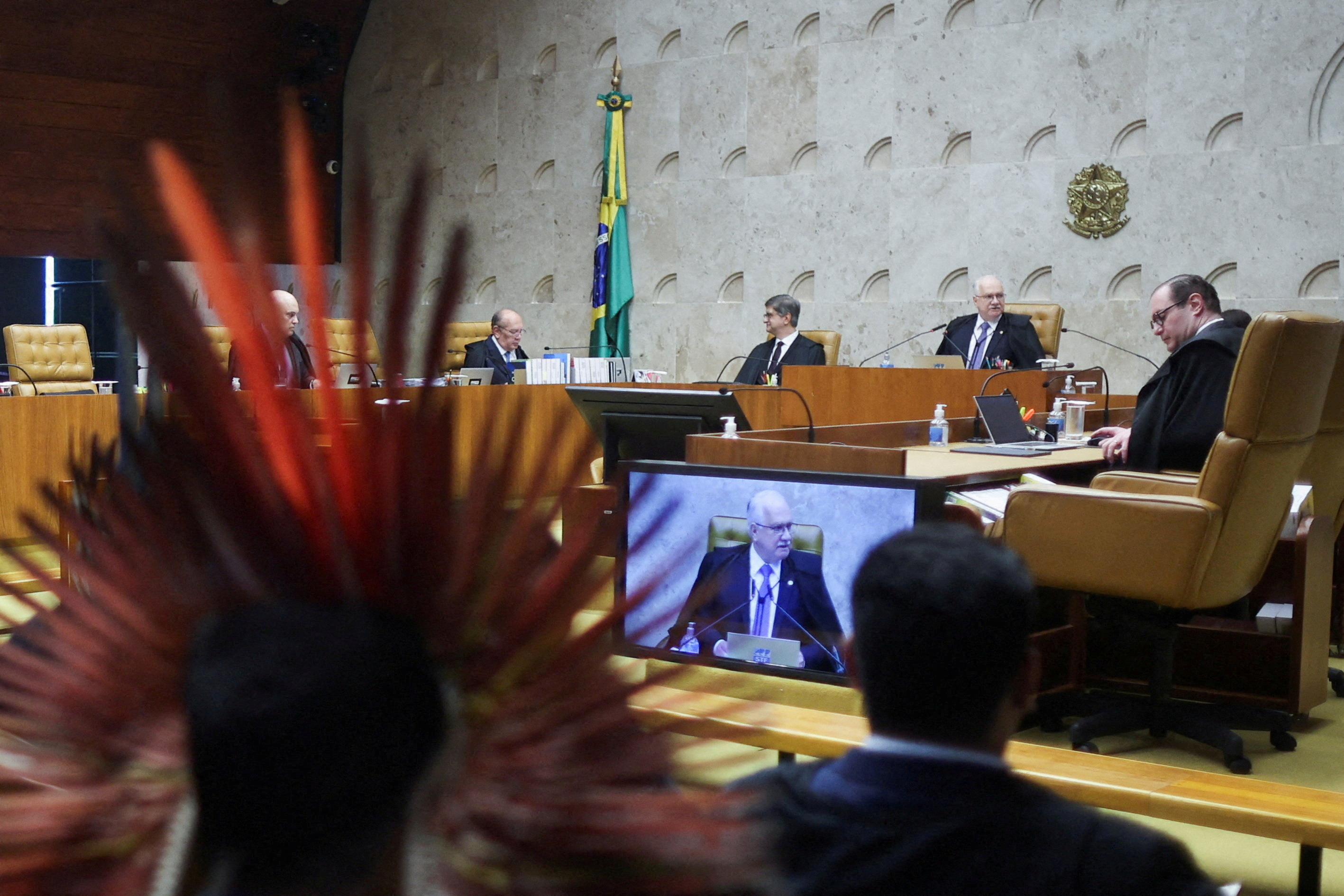 FILE PHOTO: Indigenous people attend a session where judges discuss the so-called legal thesis of "Marco Temporal" (Temporal Milestone) , at the Supreme Court in Brasilia