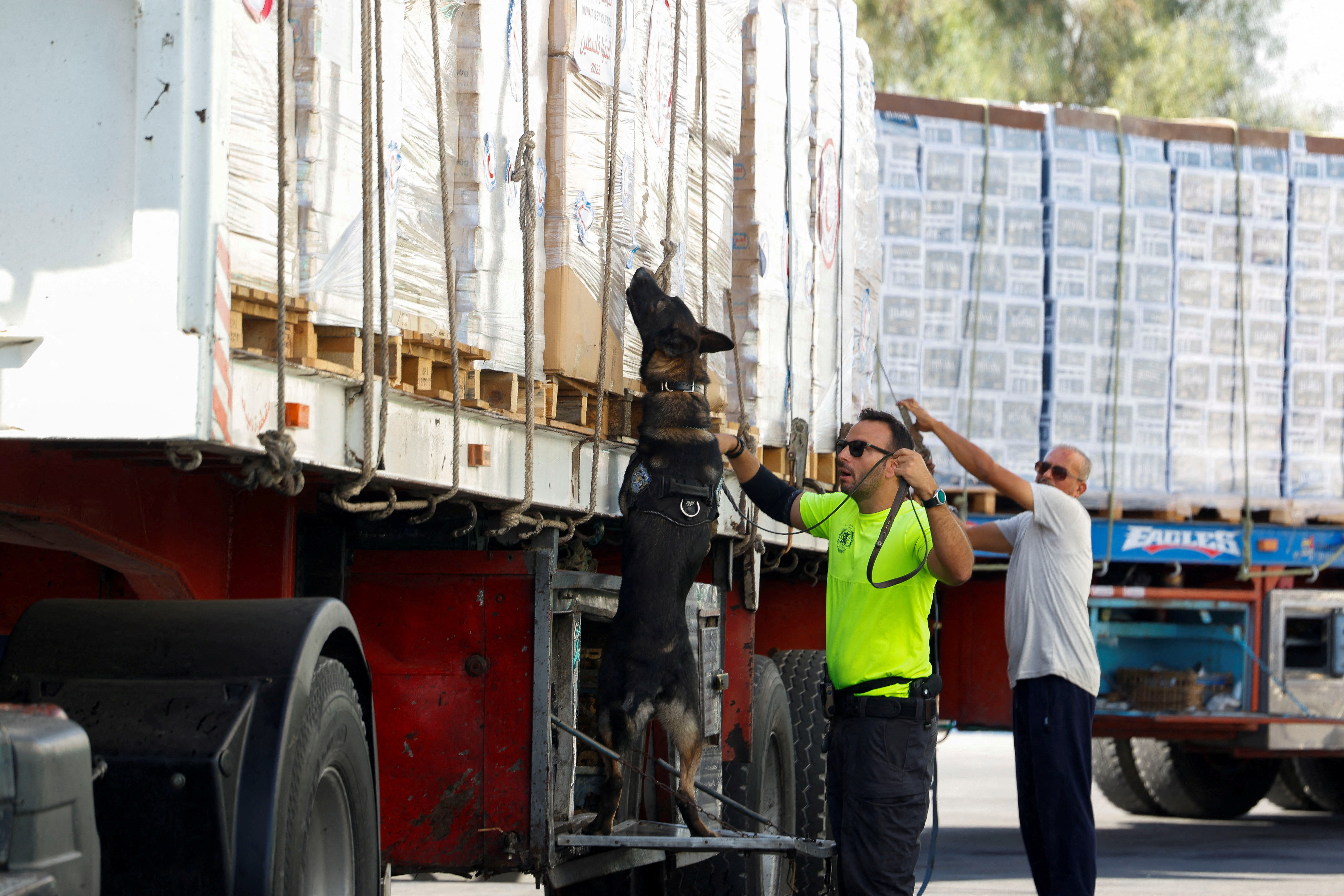 FILE PHOTO: Trucks loaded with humanitarian supplies bound for Gaza wait, as trucks are inspected by Israel, at the Nitzana border crossing