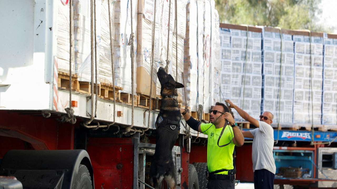 FILE PHOTO: Trucks loaded with humanitarian supplies bound for Gaza wait, as trucks are inspected by Israel, at the Nitzana border crossing