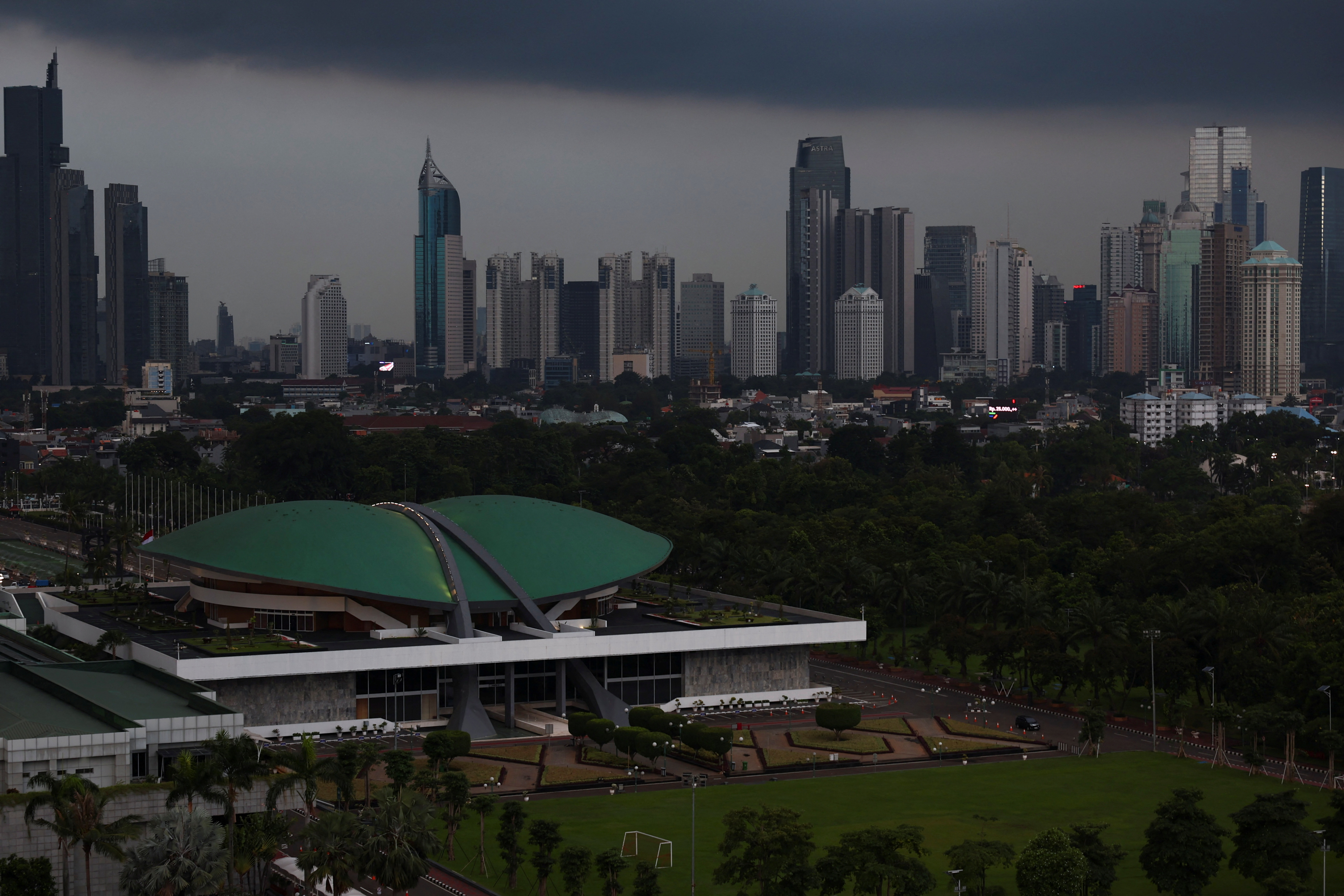Indonesian Parliament building stands with the skyline in the background in Jakarta
