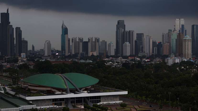 Indonesian Parliament building stands with the skyline in the background in Jakarta