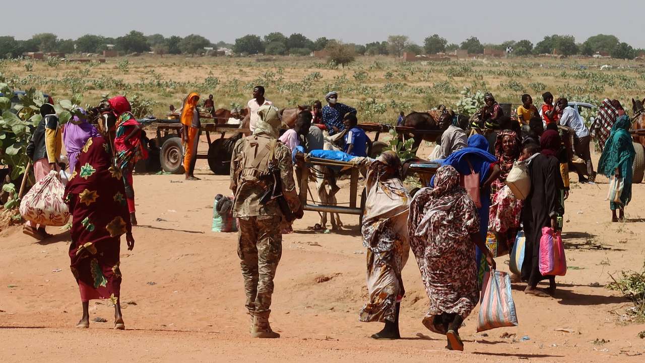 FILE PHOTO: Families escaping Ardamata in West Darfur cross into Adre, Chad, after a wave of ethnic violence, November 7, 2023.