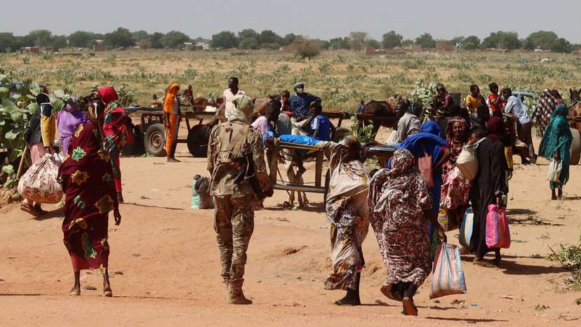 FILE PHOTO: Families escaping Ardamata in West Darfur cross into Adre, Chad, after a wave of ethnic violence, November 7, 2023.