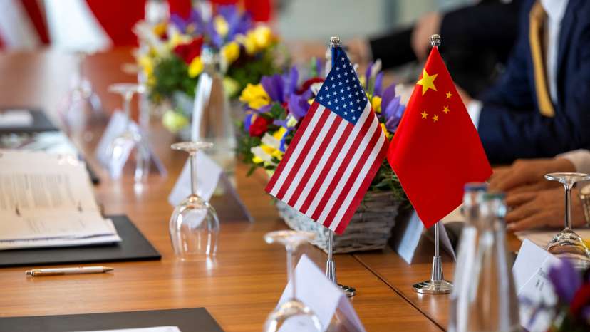 The American and Chinese flags are photographed on the negotiating table, during a bilateral meeting between the United States and China, in Geneva