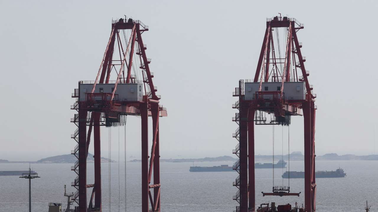 Gantry cranes stand near shipping containers at Yangshan Port outside of Shanghai