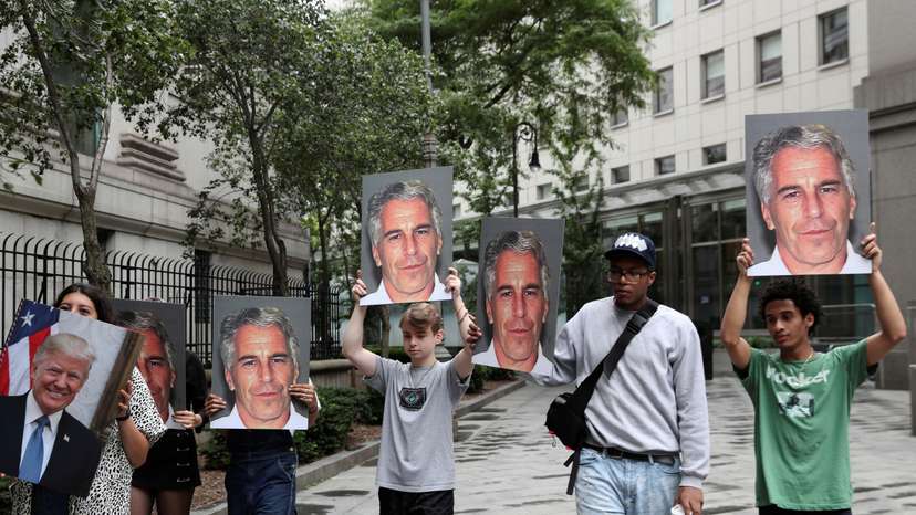Demonstrators hold photos aloft protesting Jeffrey Epstein in New York
