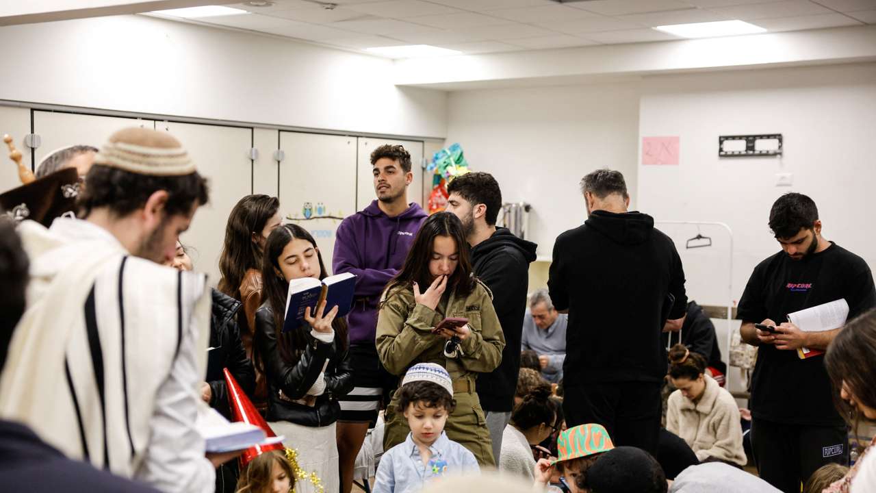 Israelis gather in a bomb shelter after missiles were launched towards Israel from Iran, in Tel Aviv