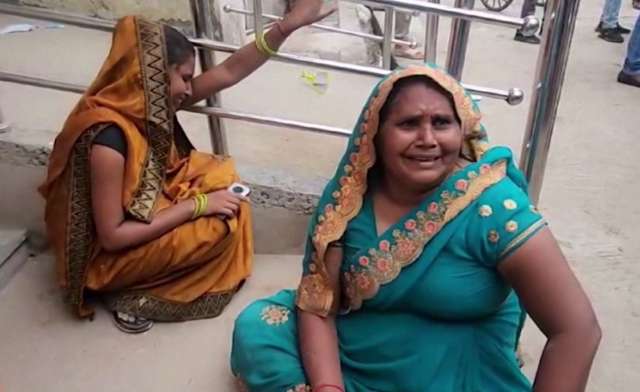 Family members react outside the Etah Hospital after a stampede at a religious event in Etah, Uttar Pradesh, India, July 2, 2024