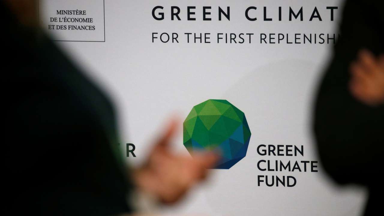 People arrive to attend the Pledging Conference of the Green Climate Fund (GCF) for the First Replenishment in Paris