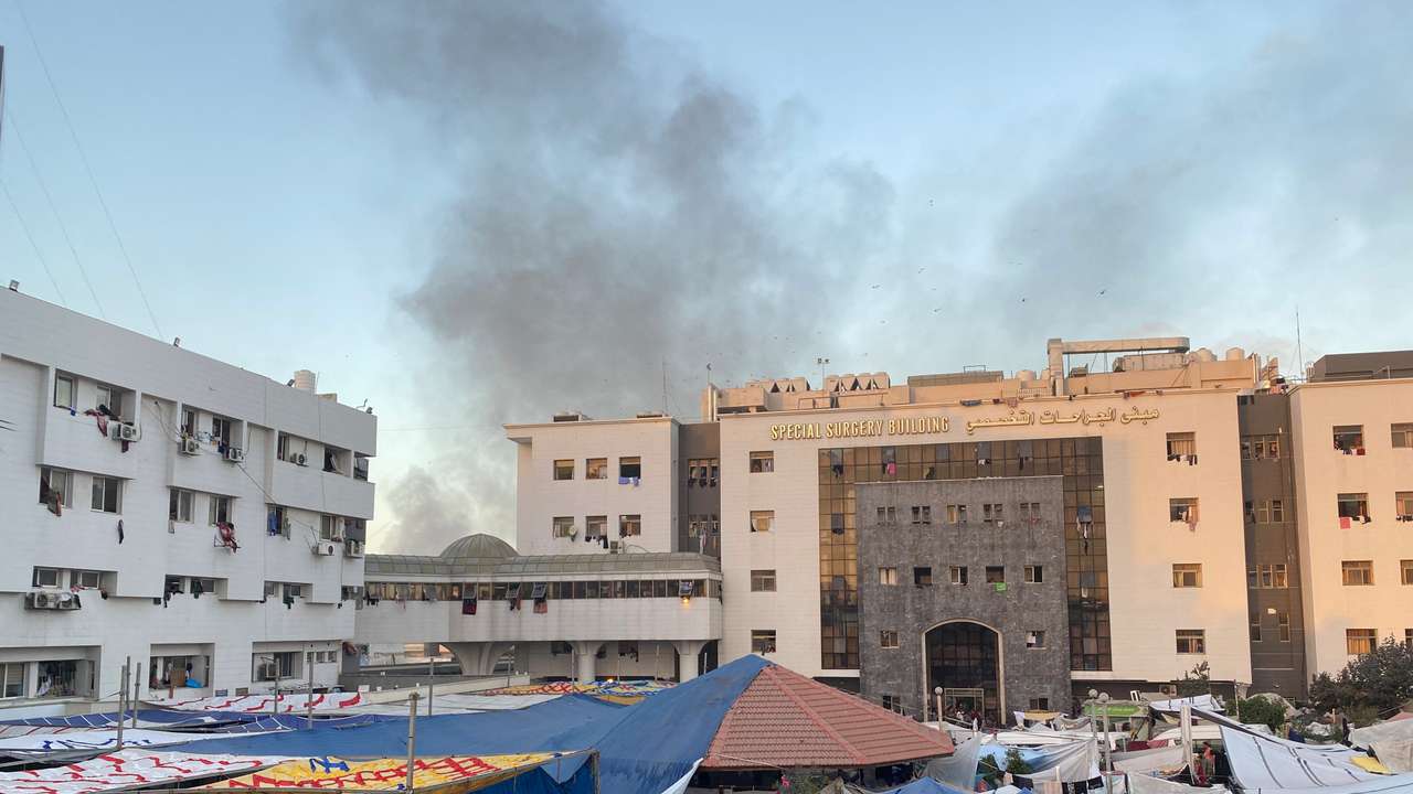 FILE PHOTO: Smoke rises as displaced Palestinians take shelter at Al Shifa hospital, amid the ongoing conflict between Hamas and Israel, in Gaza City