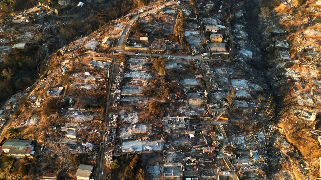 An aerial view shows the remains of houses burnt following the spread of wildfires in Vina del Mar