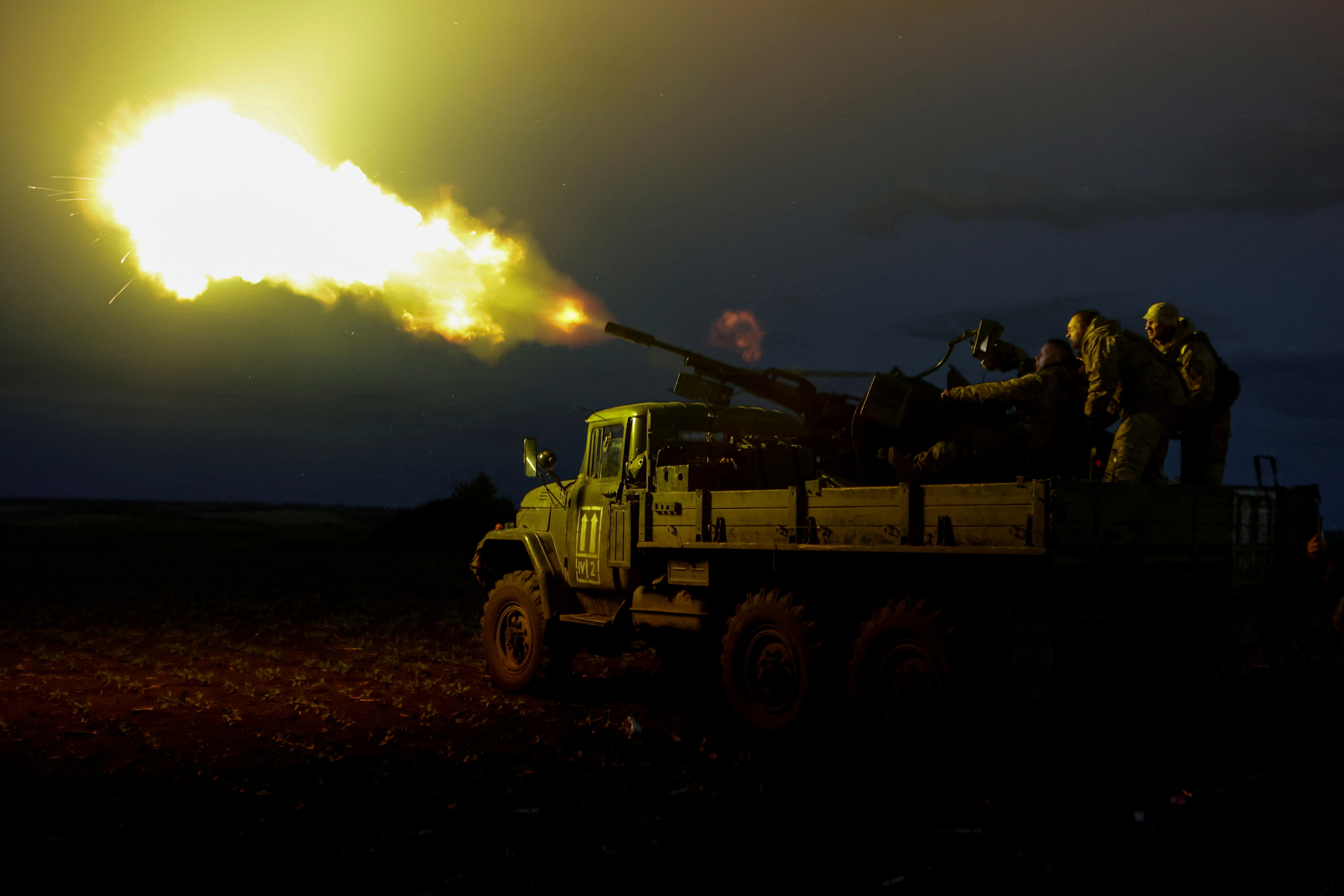 FILE PHOTO: Ukrainian servicemen from mobile air defence unit fire an anti-aircraft cannon towards a Russian drone in Kharkiv region