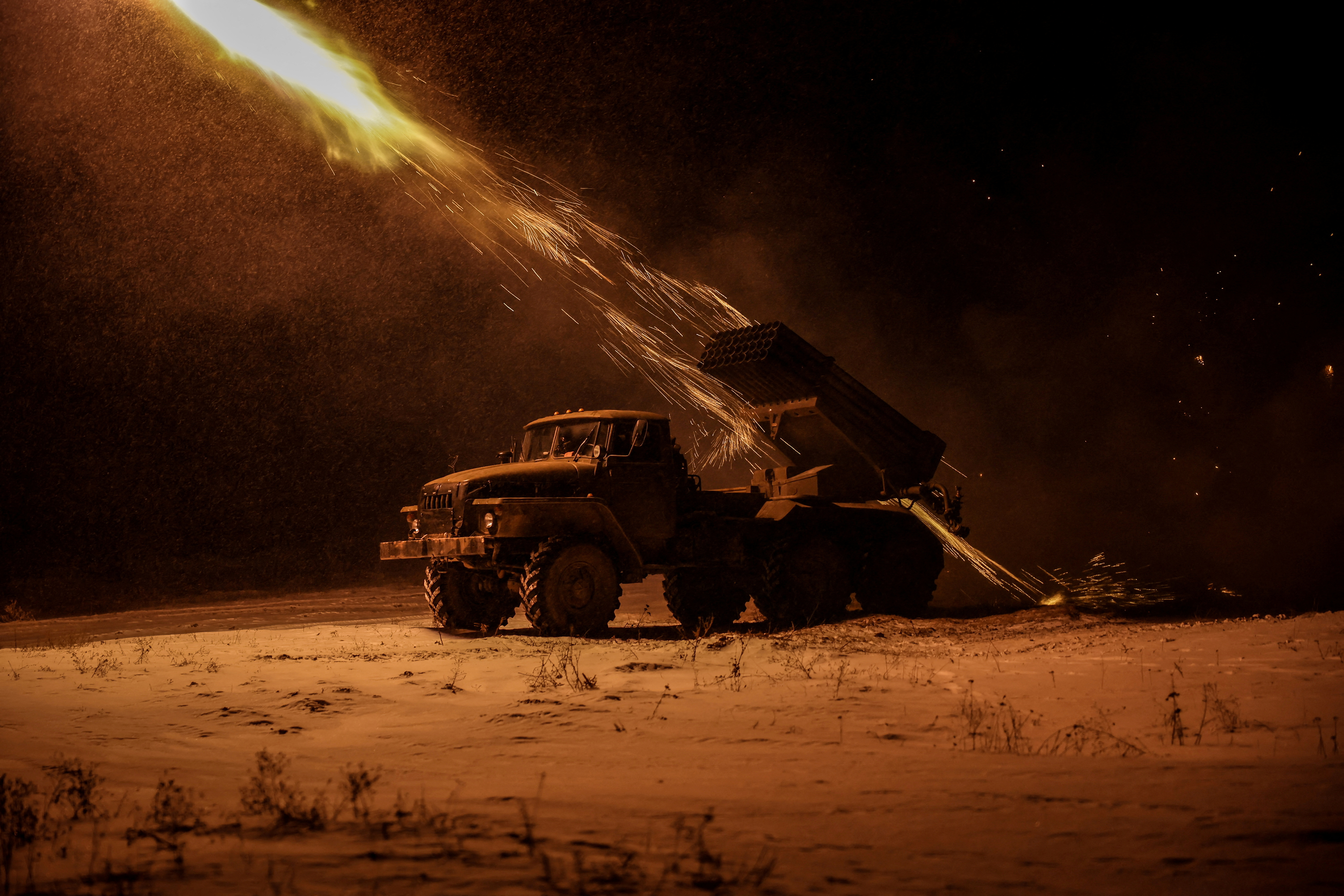 Ukrainian servicemen fire a BM-21 Grad multiple-launch rocket system toward Russian troops on a front line near the town of Chasiv Yar