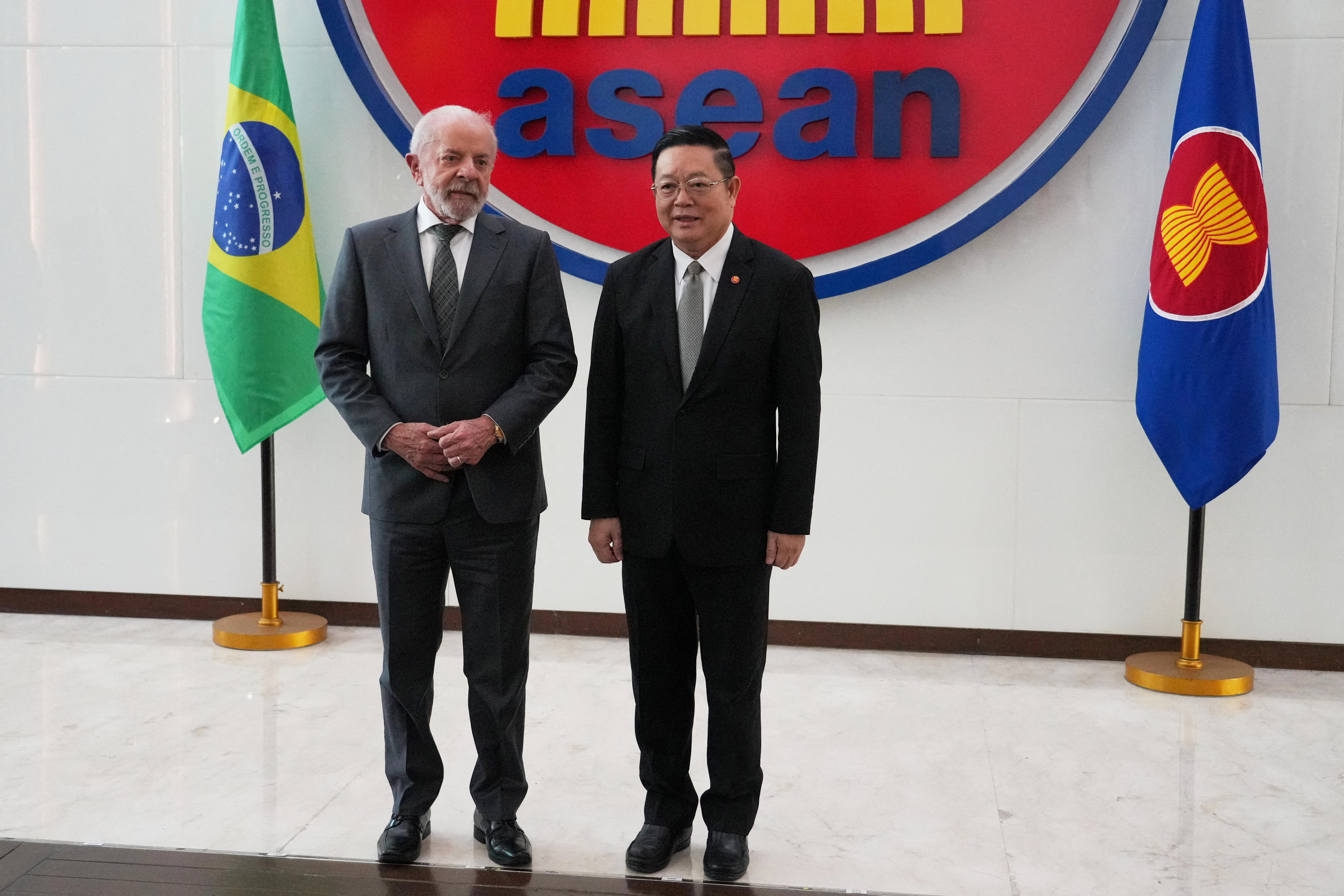 Brazil's President Luiz Inacio Lula da Silva stands for a photograph with ASEAN Secretary-General Kao Kim Hourn during their meeting in Jakarta