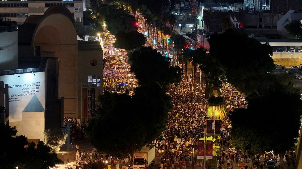 FILE PHOTO: People protest as they demand the release of all Israeli hostages and ending the war in Gaza, in Tel Aviv