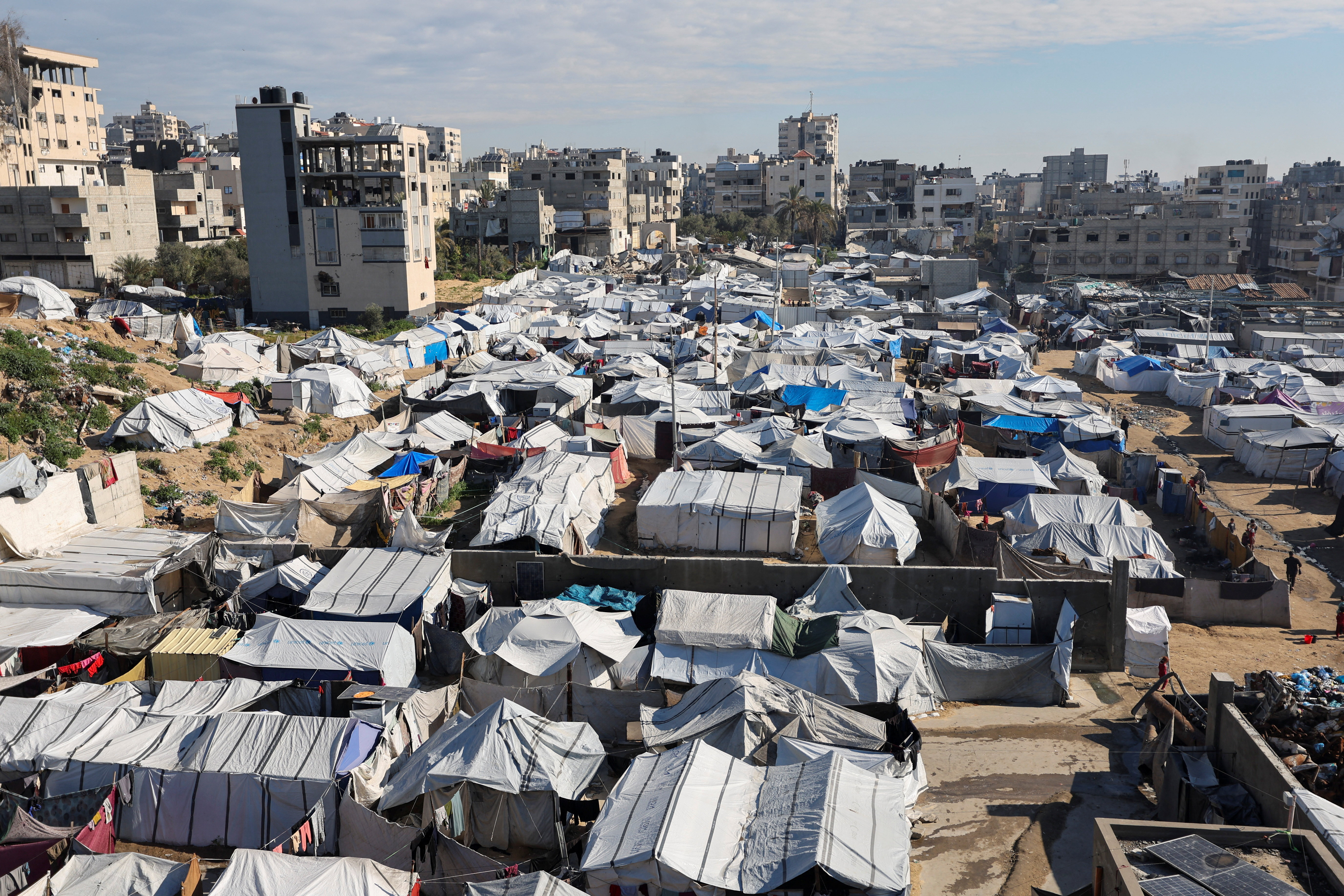 Palestinians displaced during the two-year Israeli offensive, shelter at a tent camp in Gaza City