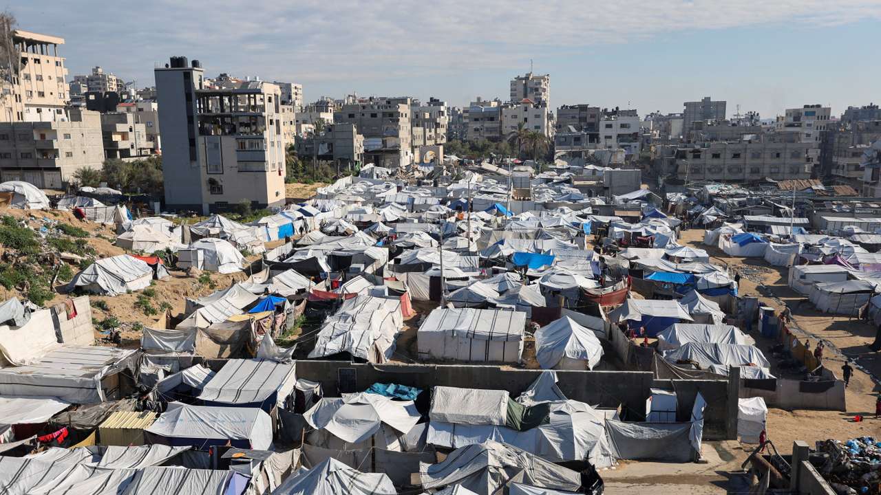 Palestinians displaced during the two-year Israeli offensive, shelter at a tent camp in Gaza City