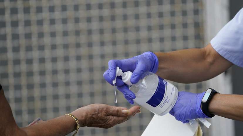 A medical team administers hand sanitiser to a resident of the Basque town of Azpeitia