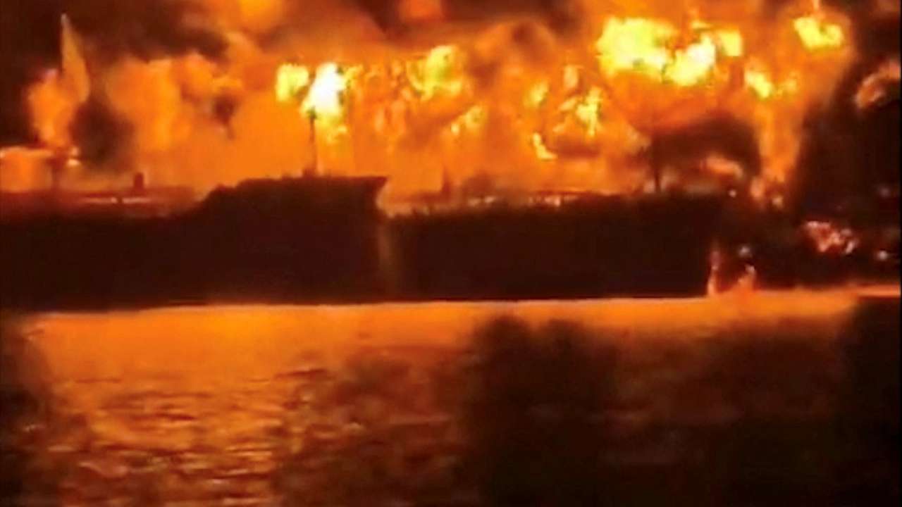A ship burns, after Iranian explosive-laden boats appear to have attacked two fuel tankers in Iraqi waters setting them ablaze