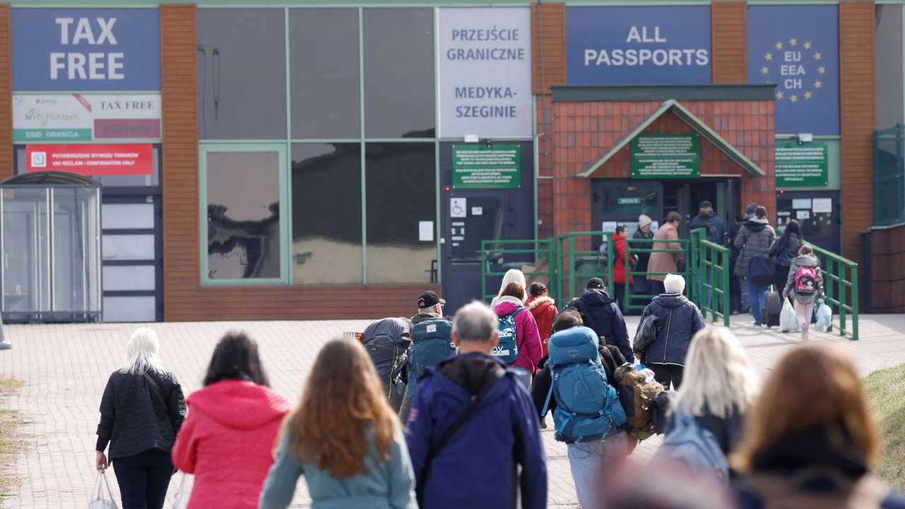 FILE PHOTO: Ukrainian refugees walk towards border crossing from Poland to Ukraine, in Medyka