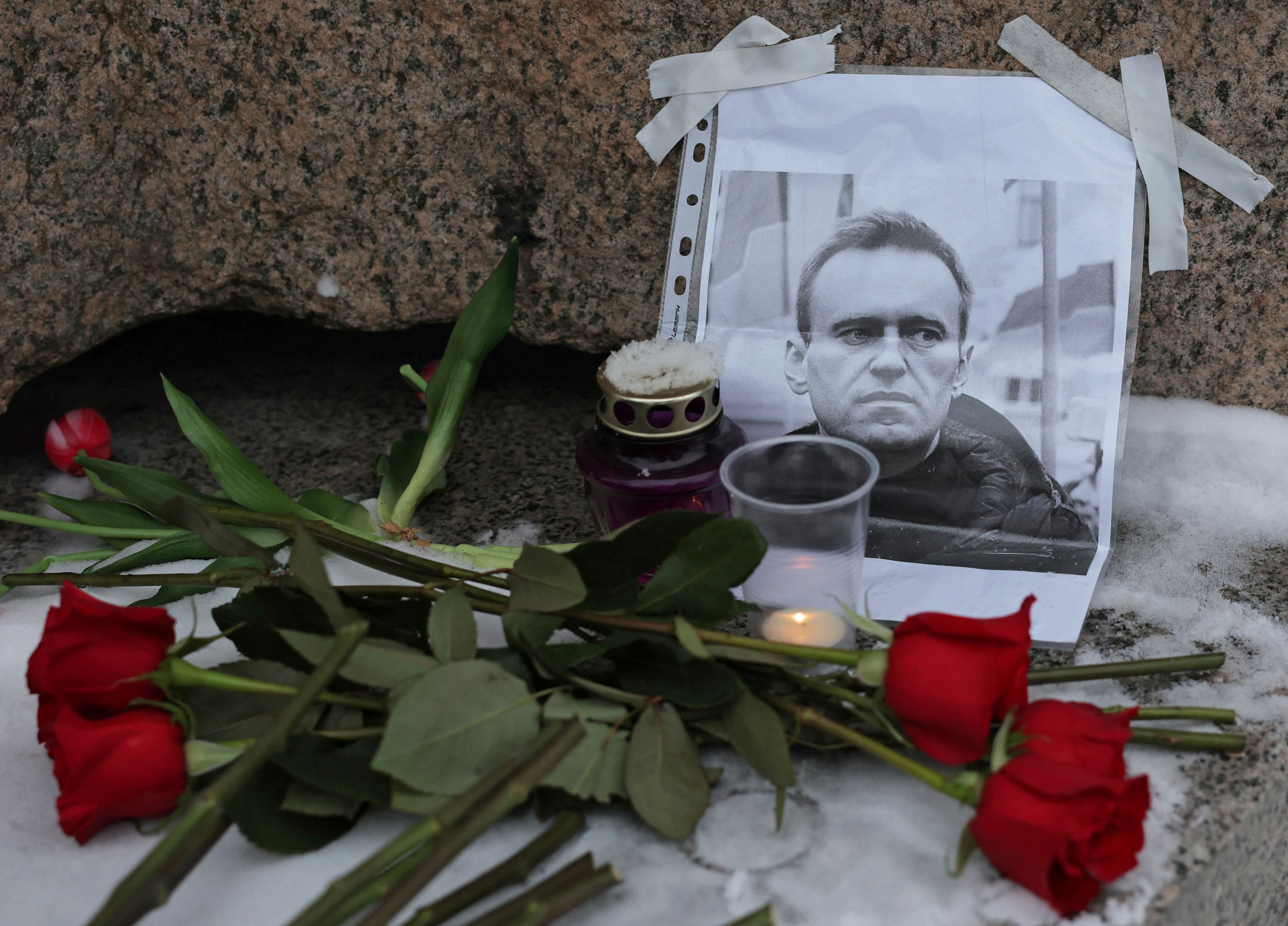 People gather at the monument to the victims of political repressions following the death of Alexei Navalny in Saint Petersburg