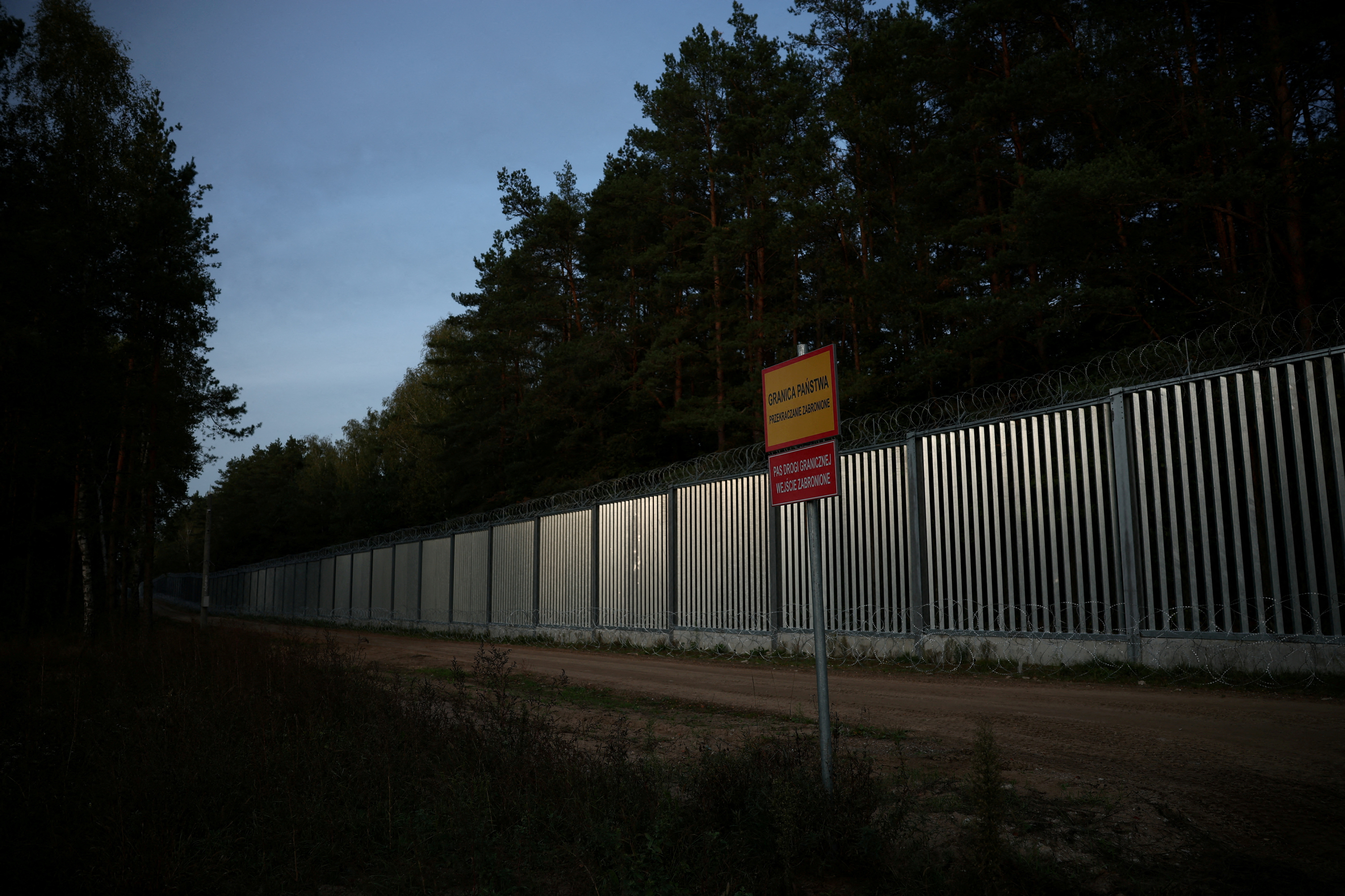 FILE PHOTO: General view of the fence on the Polish-Belarusian border at sunset, during the migrant crisis, in Opaka Duza