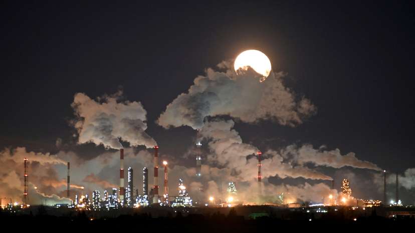 FILE PHOTO: A full moon rises over Gazprom Neft's oil refinery in Omsk