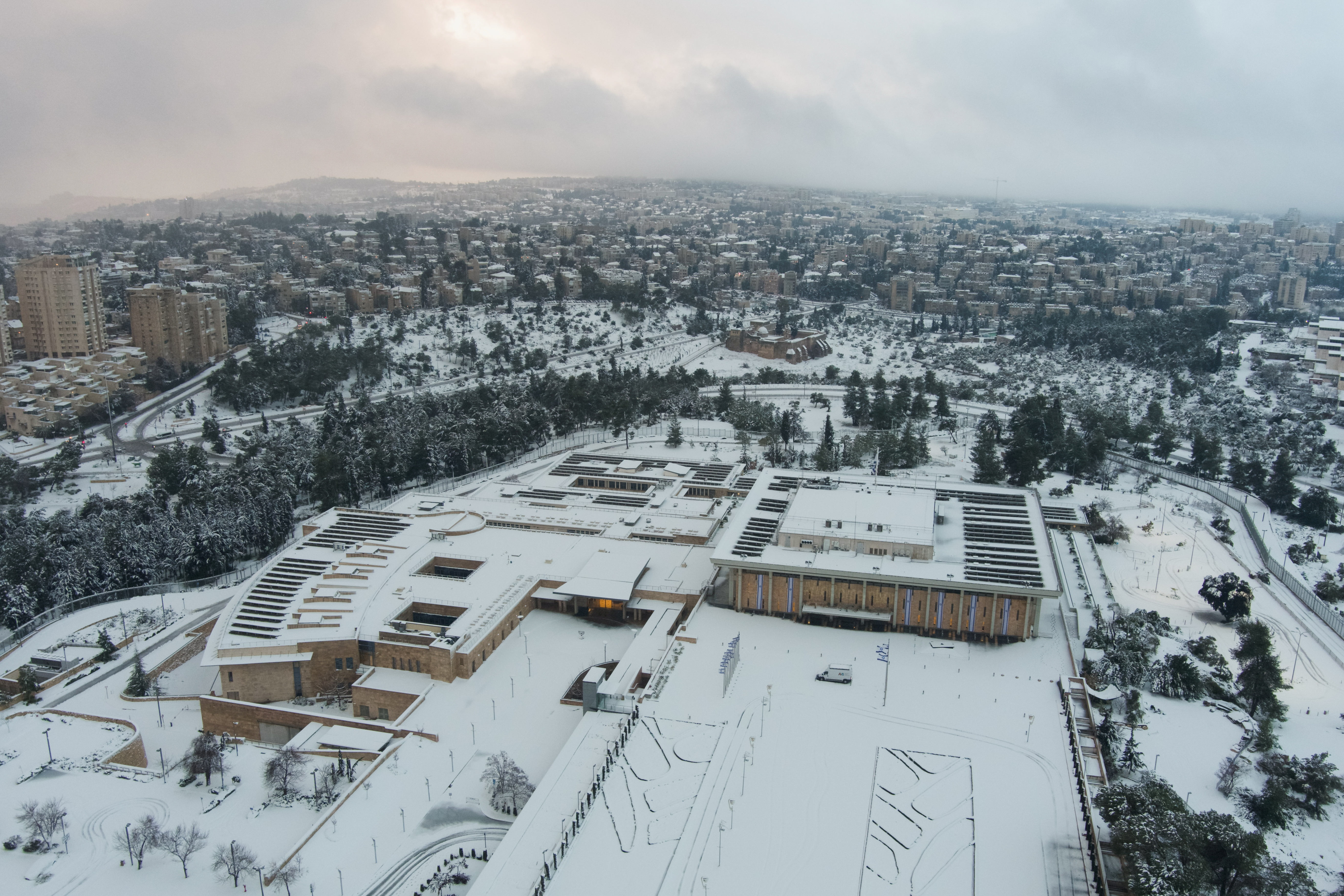 Aerial view of the Knesset, Israeli parliament building, in snow-covered Jerusalem