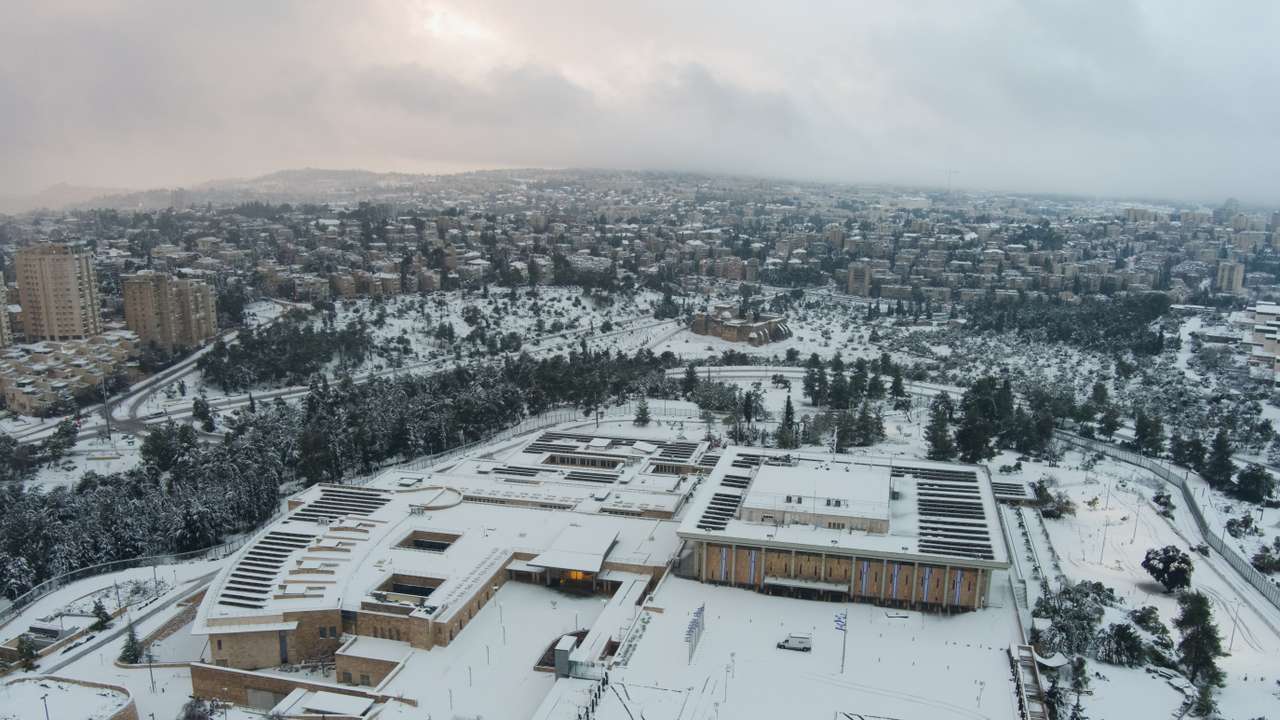 Aerial view of the Knesset, Israeli parliament building, in snow-covered Jerusalem