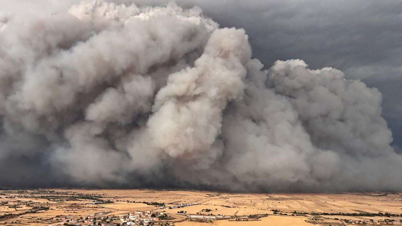 Smoke rises from a wildfire over the fields of Torrefeta i Florejacs vile, near Lleida