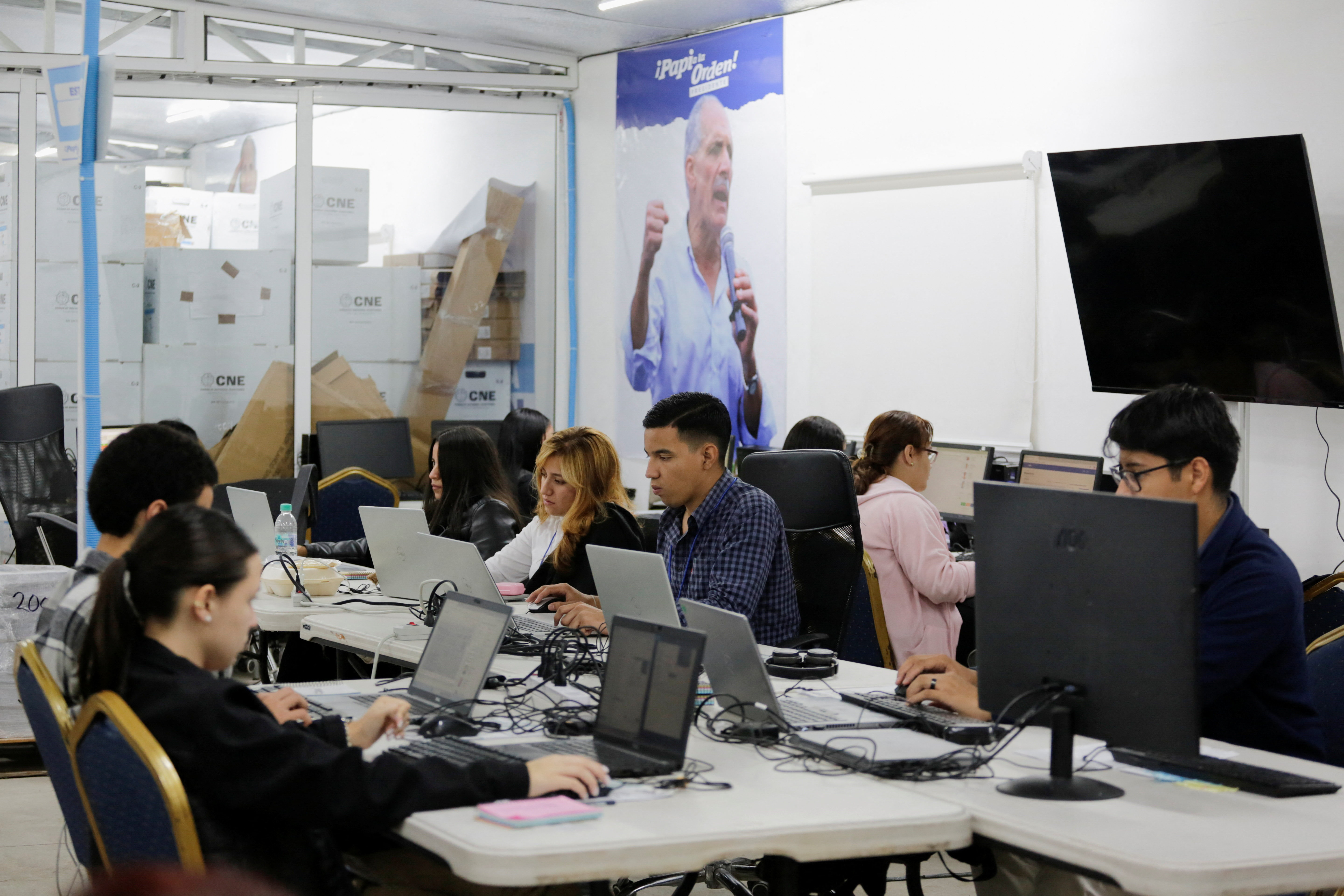 Staff members of presidential candidate Nasry Asfura of Honduras' National Party participate in the recount of electoral records