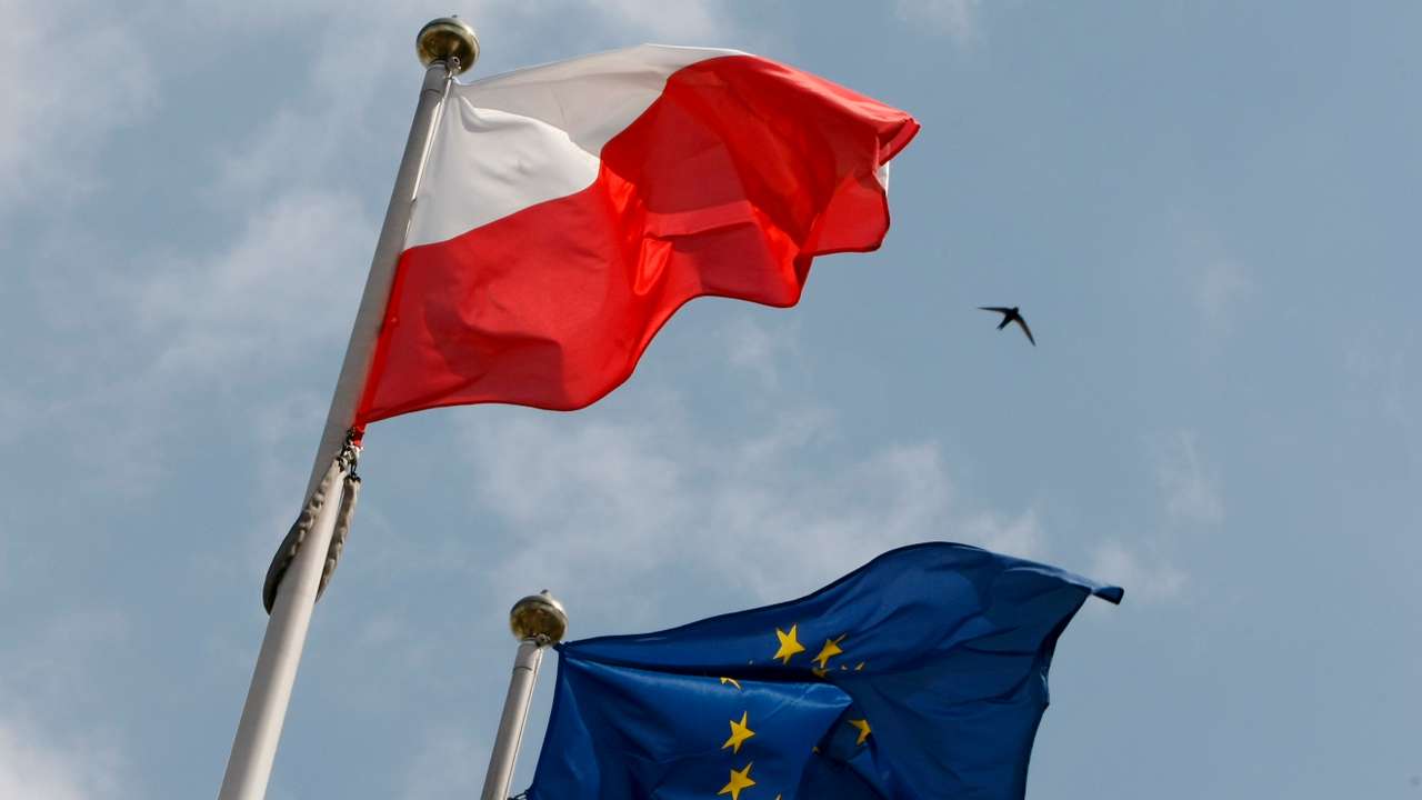 The flags of Poland and European Union flutter in front of the Polish parliament in Warsaw