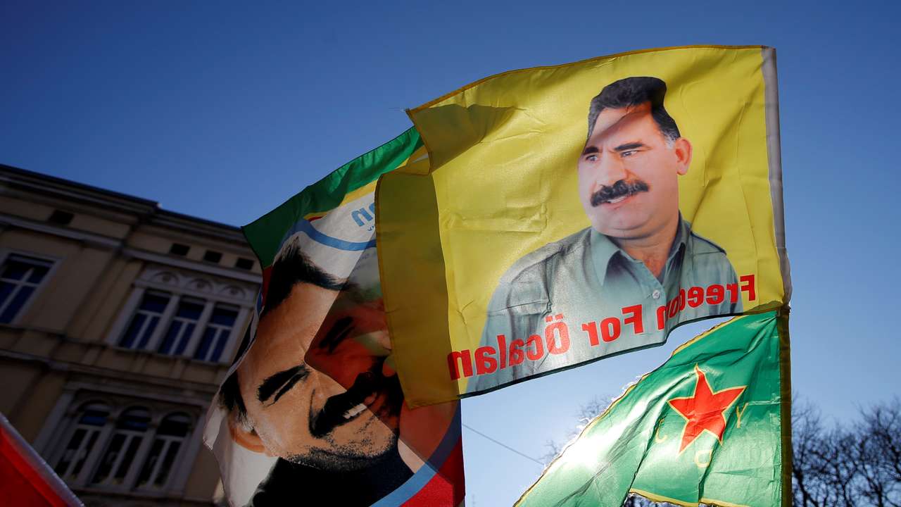 Pro-Kurd protesters hold flags with portraits of jailed PKK leader Ocalan as they take part in a demonstration in support to him in Strasbourg