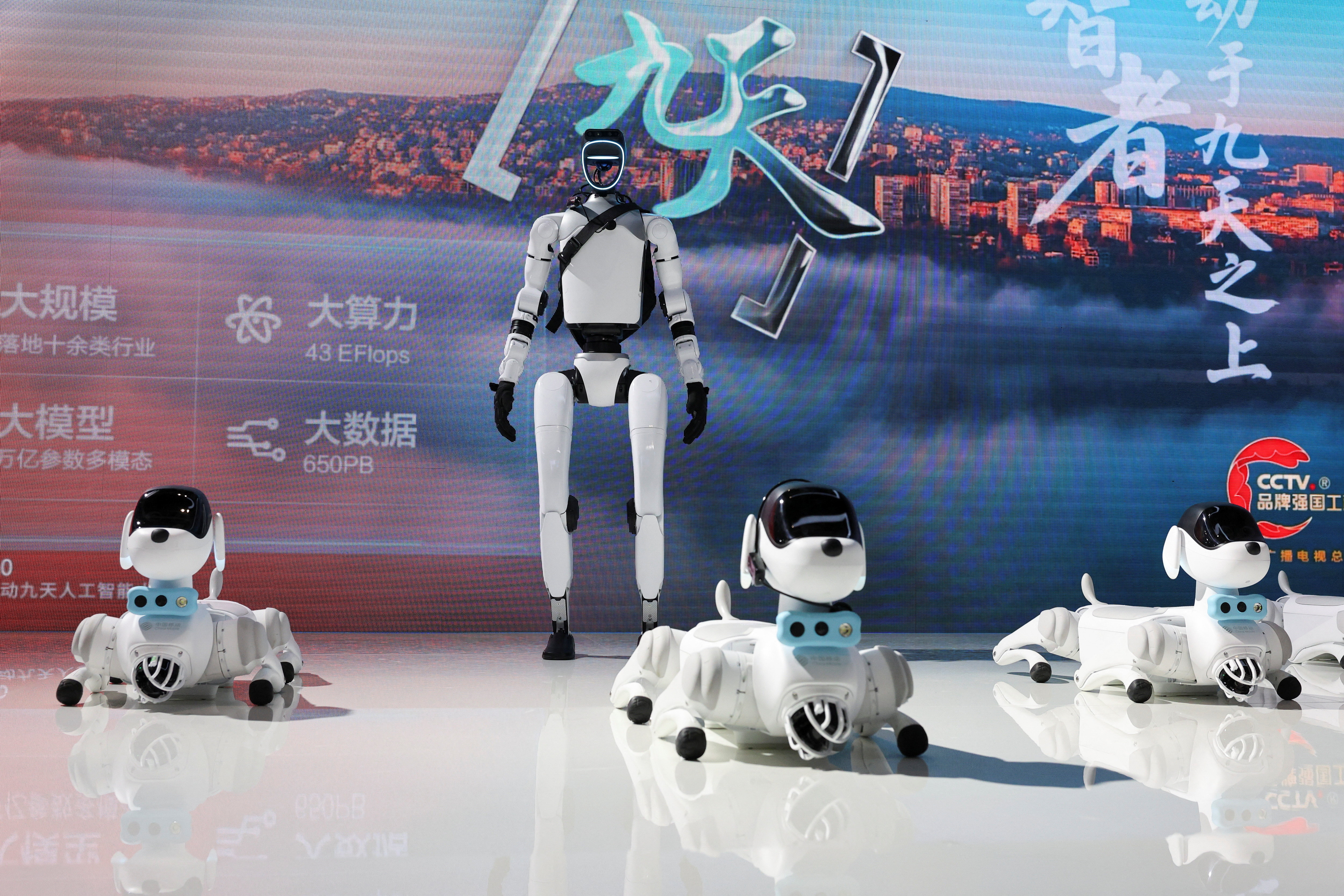 A humanoid robot and robot dogs are displayed at China Mobile booth during WAIC in Shanghai