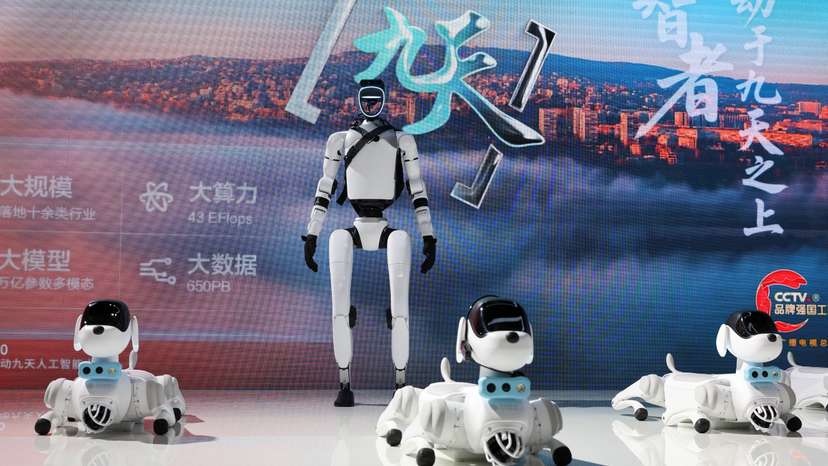 A humanoid robot and robot dogs are displayed at China Mobile booth during WAIC in Shanghai