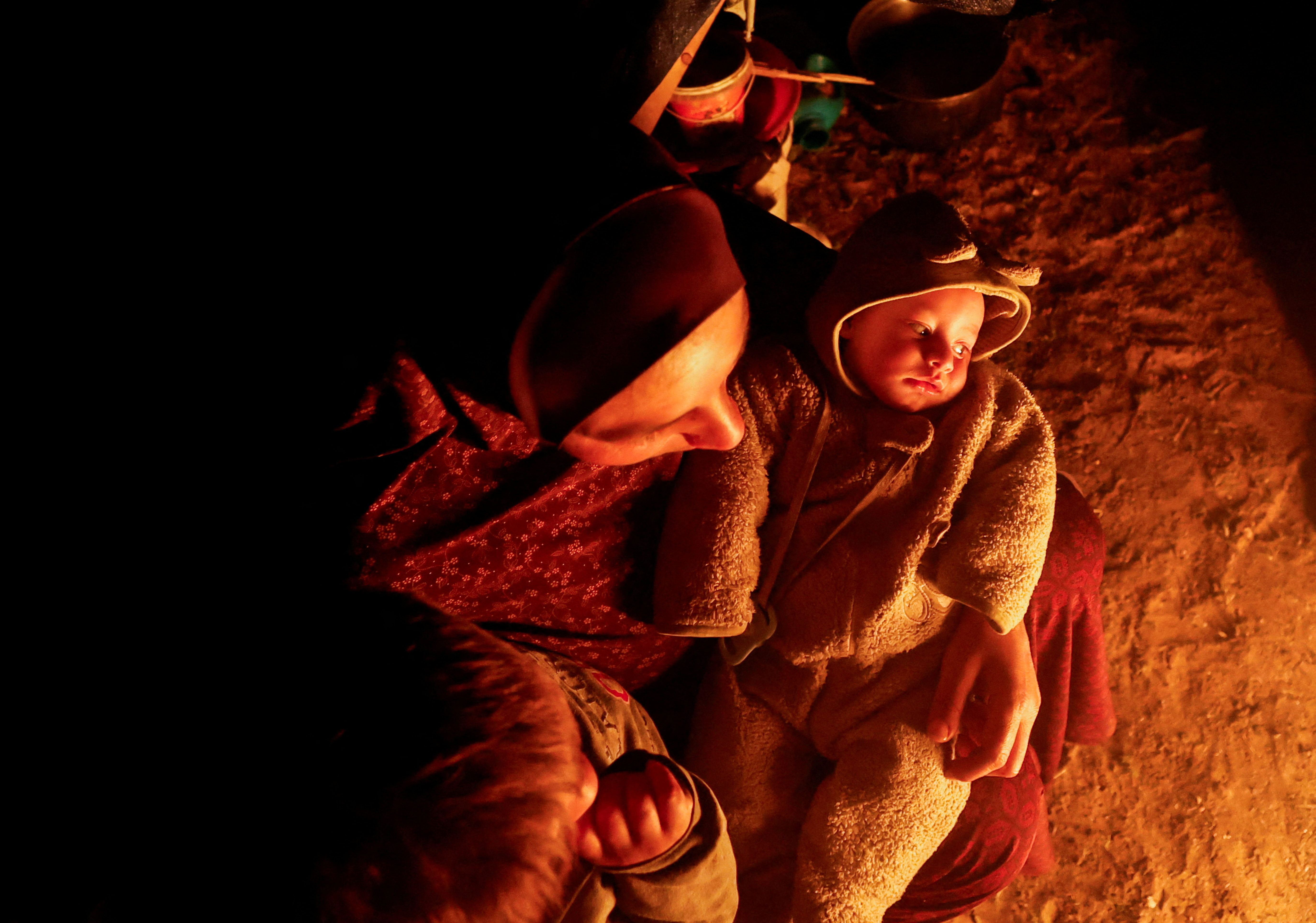 Palestinians who fled their houses due to Israeli strikes shelter in a tent, in Rafah