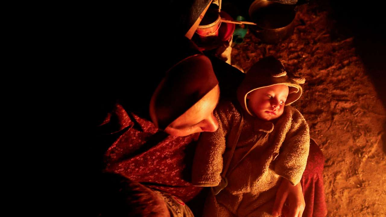 Palestinians who fled their houses due to Israeli strikes shelter in a tent, in Rafah