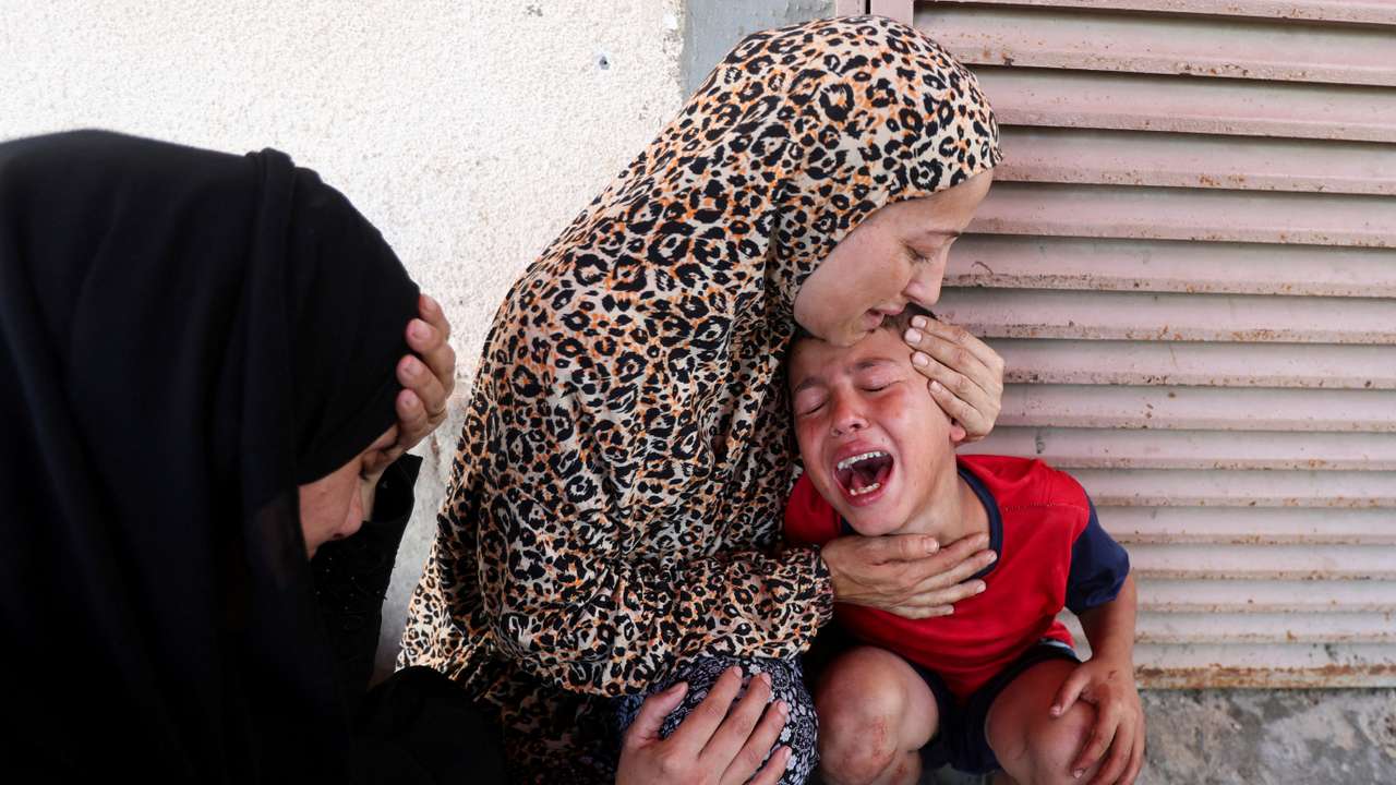 Palestinian casualties are carried into Al-Aqsa Martyrs Hospital in Deir al-Balah