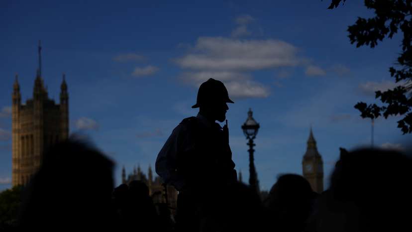 A police officer oversees the crowd in London, Britain